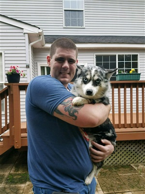 Brian holding a cute dog